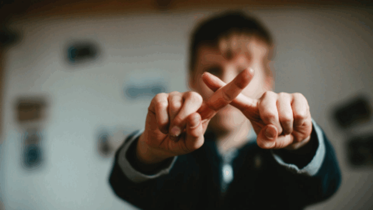 Kids showing no by hand fingers