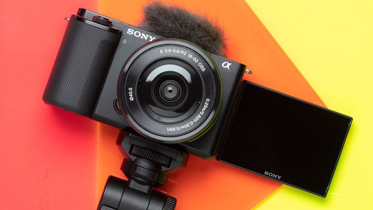 Vlogger using Sony ZV-E10 mirrorless camera outdoors